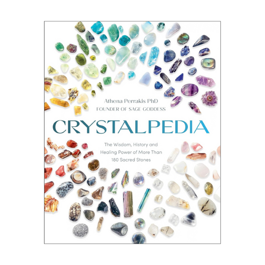 The front cover of the book 'Crystalpedia' by Athena Perrakis PhD, featuring a colorful array of various polished and raw crystals arranged in a circular pattern on a white background.